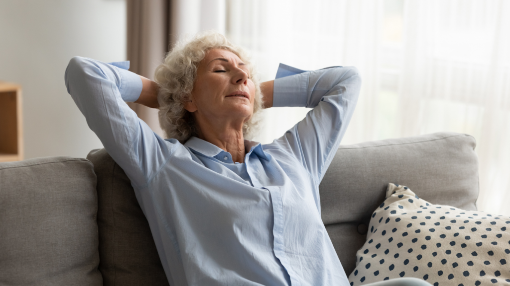 A mature woman rests on her couch because it's an essential part of healing a fracture.