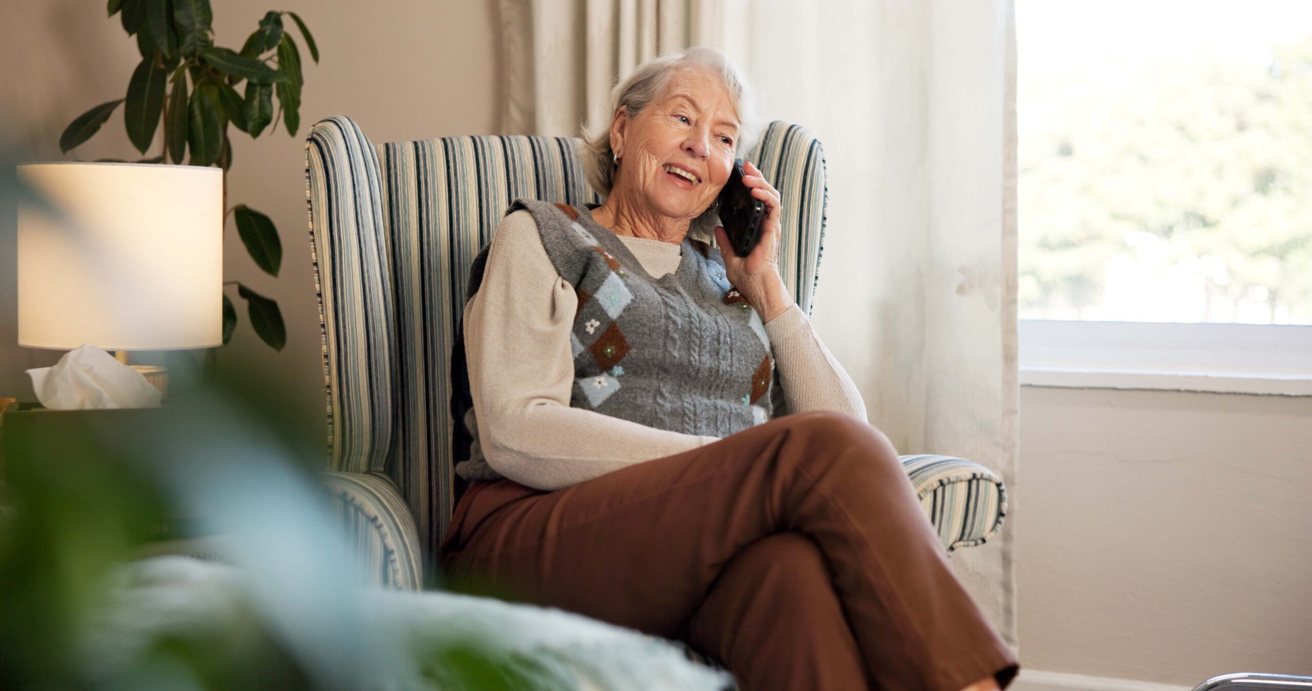 mature adult talking phone living room