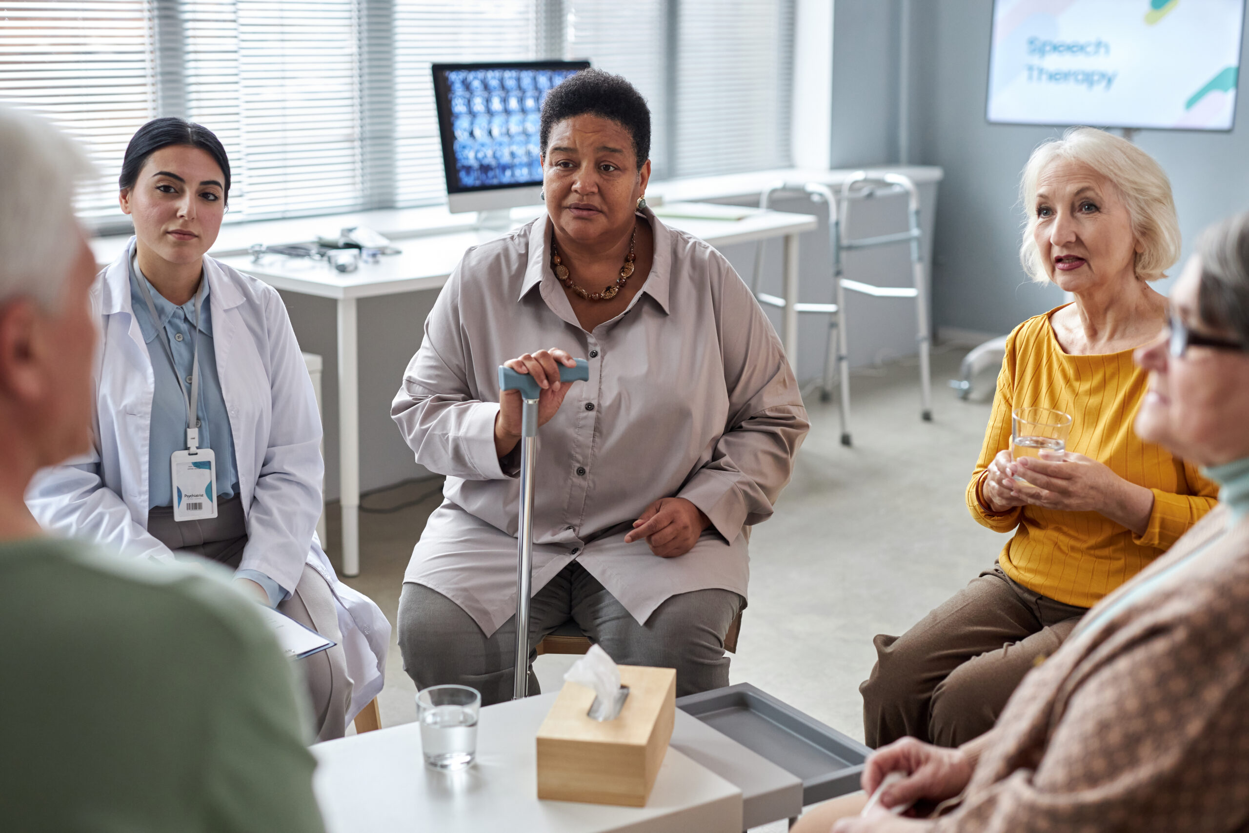 Older adults speaking with a care team about fracture recovery